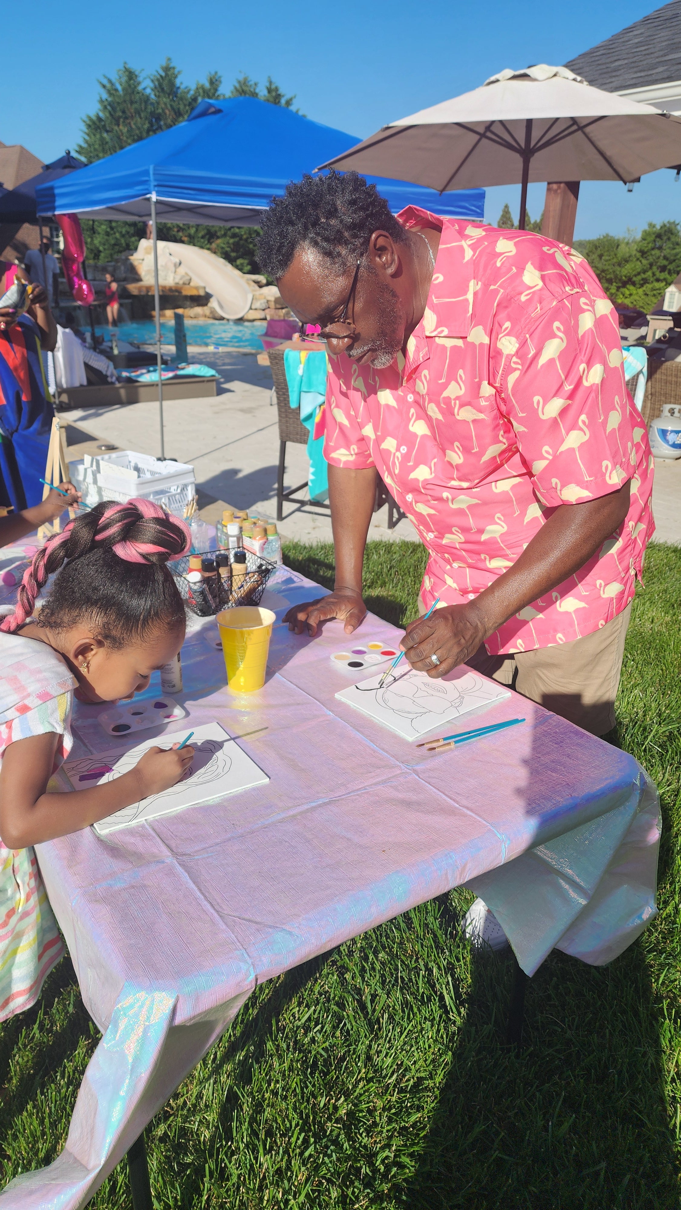 Man and child at a table with supplies outdoors