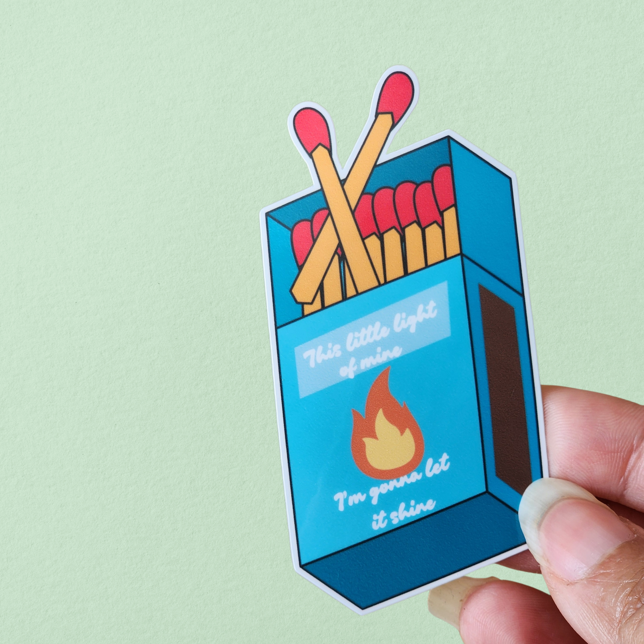 Blue matchbox illustration with flame on front 