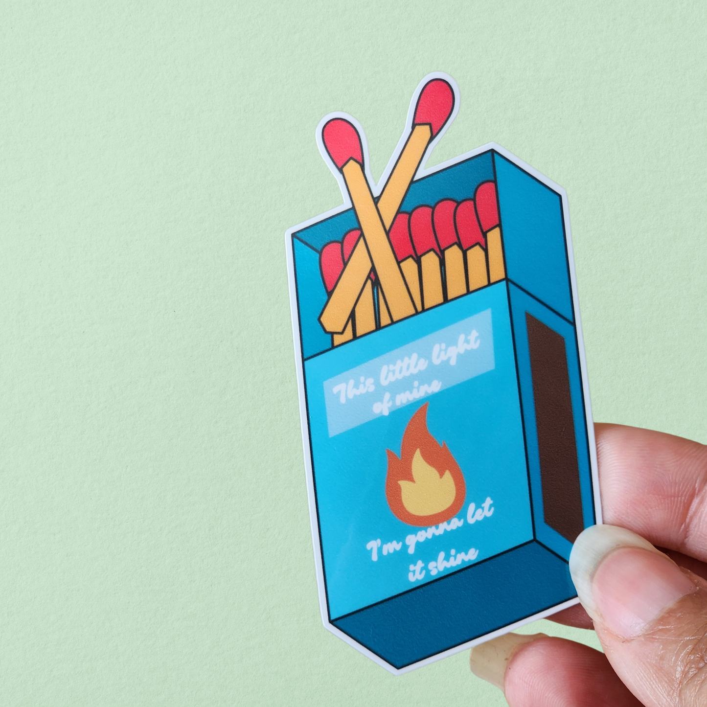 Blue matchbox illustration with flame on front 