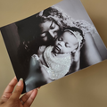 A custom glittered photo print depicting a close-up of a child resting their head on an adult's chest, with the child wearing a glittery headband.