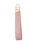 a pink cordoroy with gold dot wristlet keychain